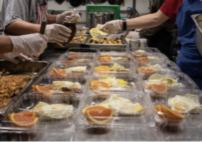 Volunteers prepare breakfast to go at The Haven. Photo credit: Zack Wajsgras.